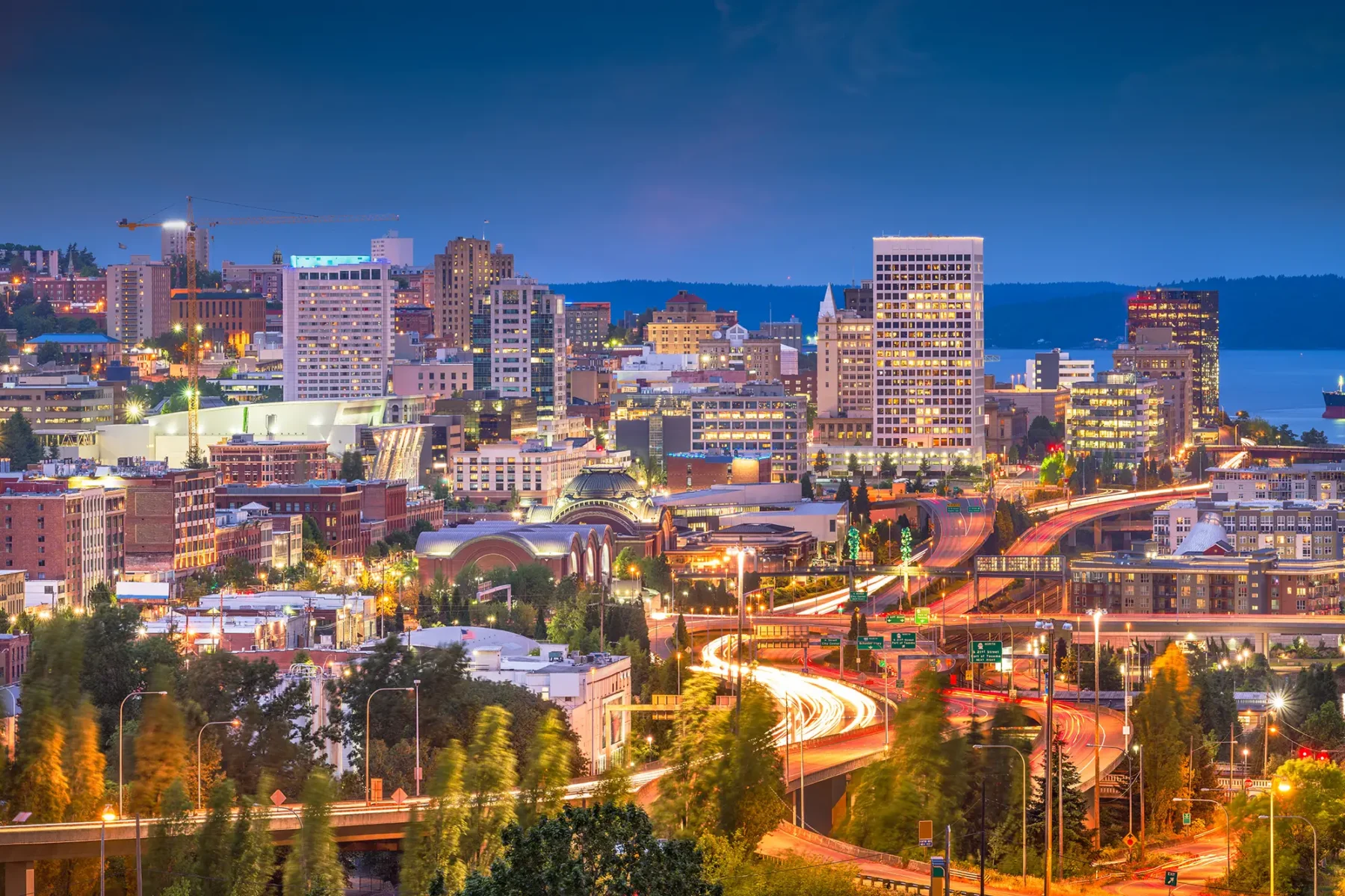 Downtown Tacoma, Washington at dusk with ocean in background