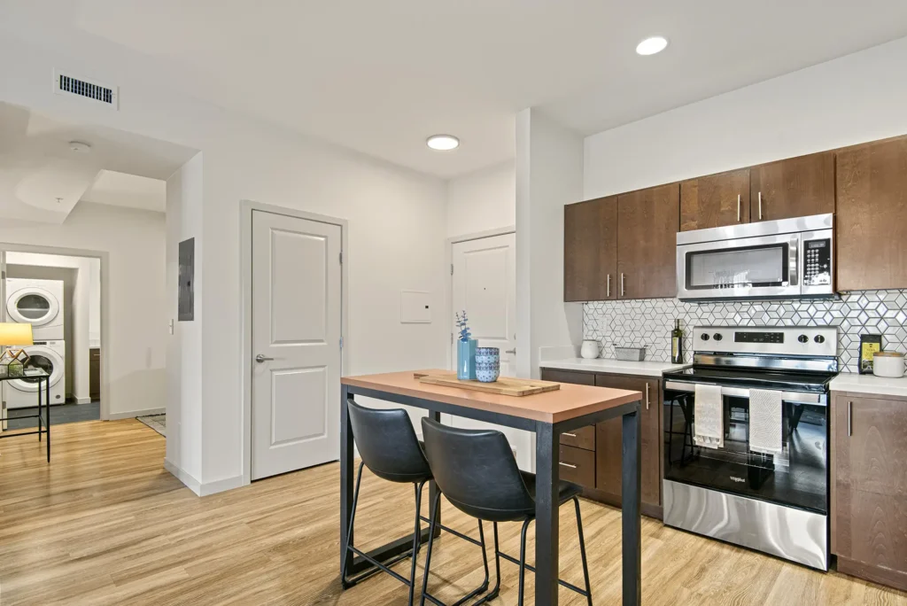 Kitchen with island seating next to entryway